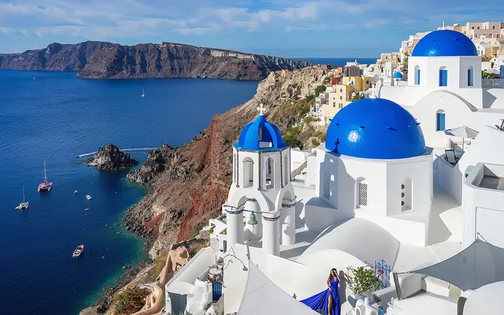 Blue-domed churches in Oia above the Santorini caldera