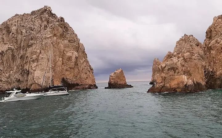 El Arco rock formation at Land's End with small boats in front