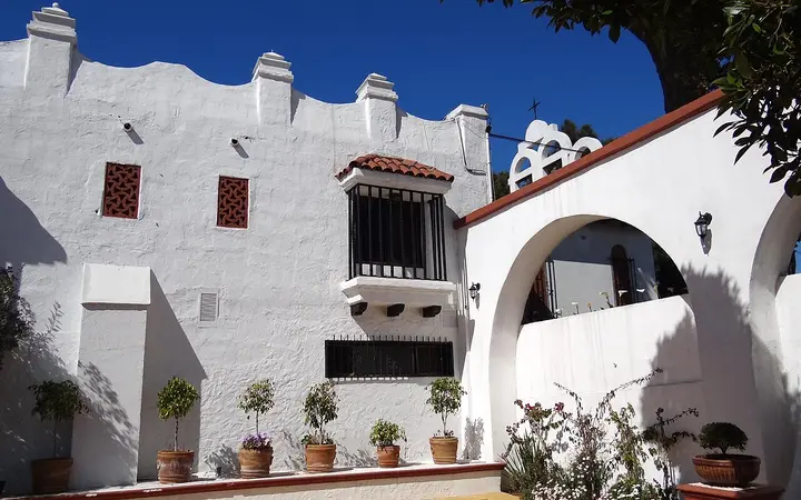 White Spanish-style facade and arches of the former Hotel Riviera del Pacífico