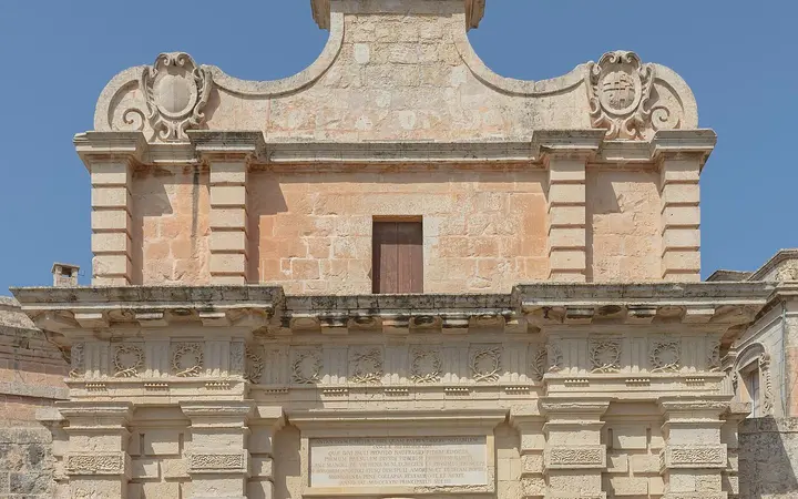 Baroque stone Main Gate of Mdina topped by a flagpole