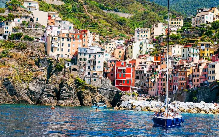Colourful houses of Riomaggiore stacked above its small harbour in the Cinque Terre