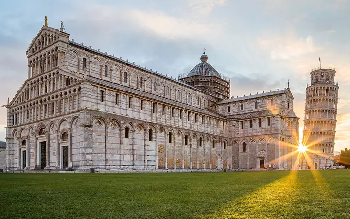Pisa Cathedral and the Leaning Tower at sunrise in Piazza del Duomo