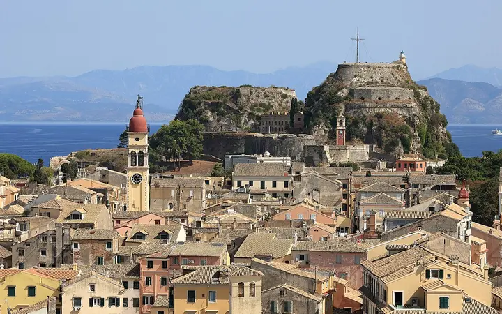 Old Fortress headland rising behind the rooftops of Corfu Old Town