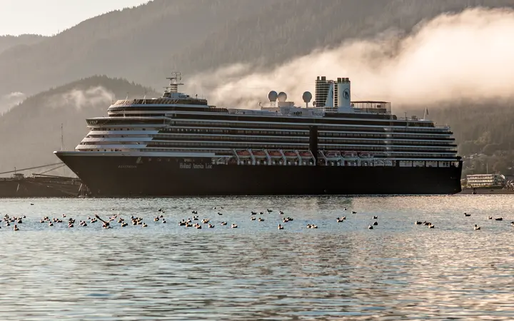 Holland America's Westerdam at the AJ Dock in Juneau with mountains and low clouds behind