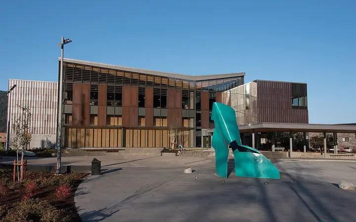 Modern brick and glass Father Andrew P. Kashevaroff building housing the Alaska State Museum in Juneau, with a teal sculpture in front