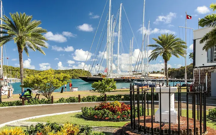 Palm-lined lawn and moored sailing yachts at Nelson's Dockyard, English Harbour, Antigua