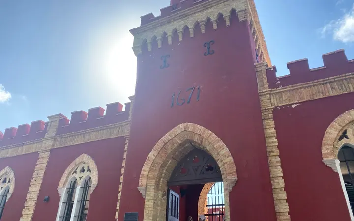 Red-walled clock tower and entrance of Fort Christian in Charlotte Amalie, dated 1671