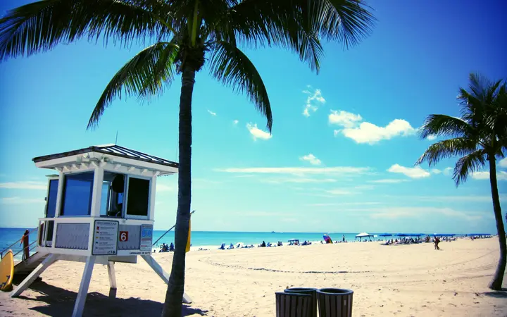 Lifeguard tower and palm trees on the sand at Las Olas Beach, Fort Lauderdale
