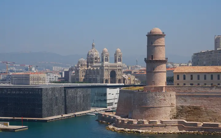 The Mucem museum and Fort Saint-Jean tower at the entrance to the Vieux-Port, with La Major cathedral behind