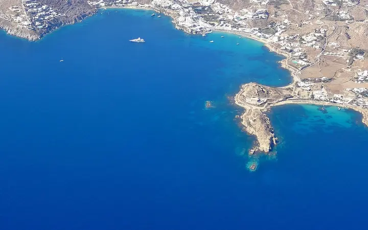 Aerial view of Platis Gialos bay and beach on Mykonos's south coast