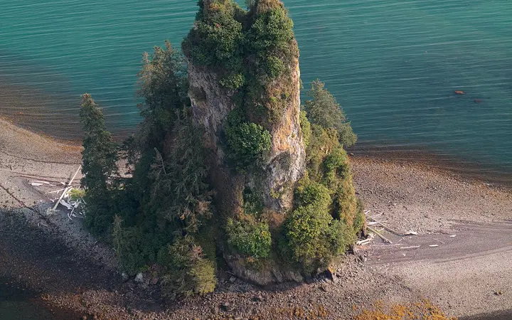 Aerial view of New Eddystone Rock, a forested volcanic pillar in Behm Canal, Misty Fjords National Monument