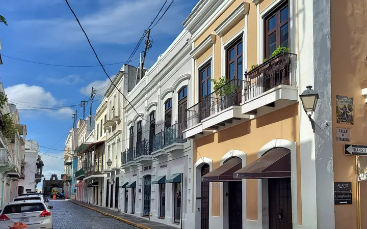 Pastel-colored colonial buildings with balconies along Calle del Cristo in Old San Juan