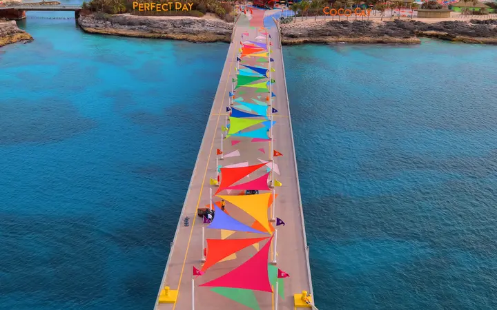 The CocoCay cruise pier with colourful pennants leading from the ship to the island