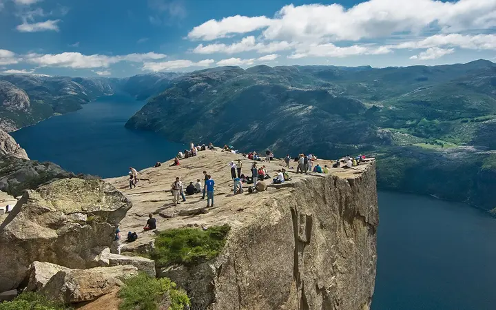 Hikers on the Preikestolen plateau above Lysefjorden