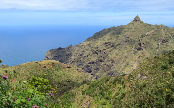 The Roque de Taborno peak rising above green ridges in the Anaga mountains