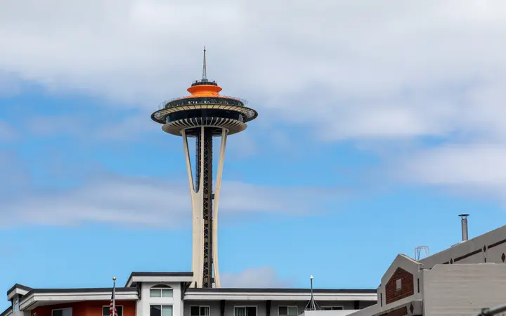 The Space Needle against a blue sky, seen from 4th Avenue in Seattle
