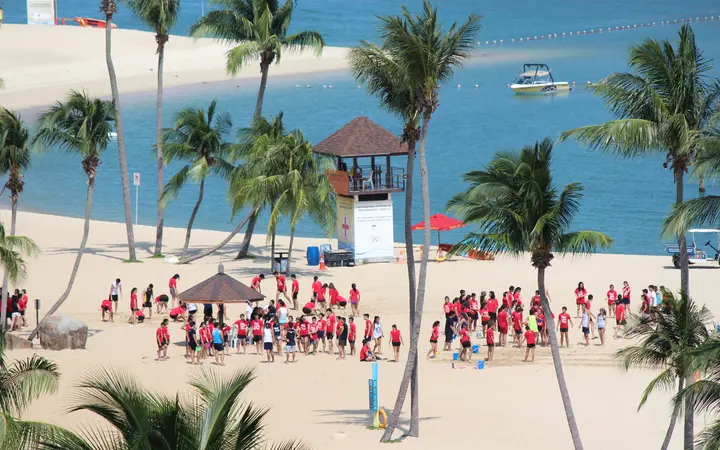 Palm-lined Siloso Beach on Sentosa island with a lifeguard tower