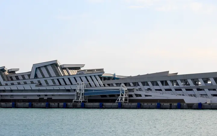 The wave-roofed Marina Bay Cruise Centre Singapore terminal building seen from the water