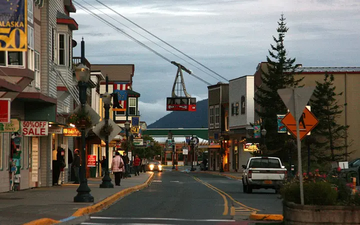 Shops along South Franklin Street in Juneau with a Mount Roberts Tramway cabin above the street