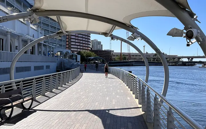Shaded section of the Tampa Riverwalk boardwalk beside the river