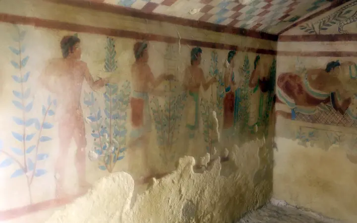 Etruscan wall paintings of banqueters and musicians inside the Tomb of the Leopards at Tarquinia