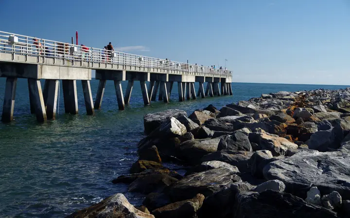 Anglers on the Jetty Park fishing pier beside the rock jetty at Port Canaveral