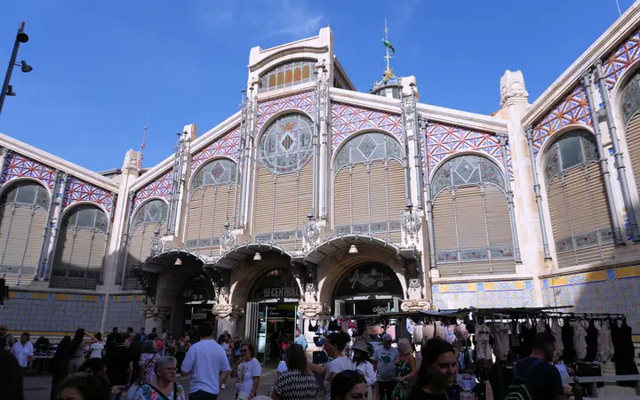 Facade of Valencia's Mercado Central with shoppers at the entrance