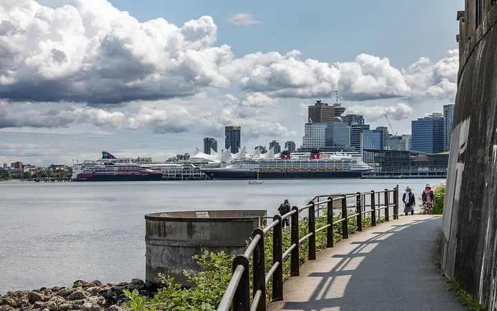 Stanley Park Seawall path with cruise ships at Canada Place in the distance