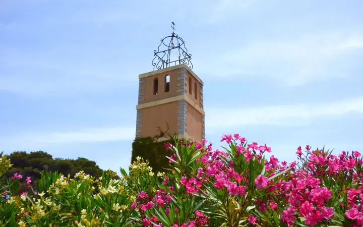 Bell tower among oleanders on Île de Bendor under a blue sky