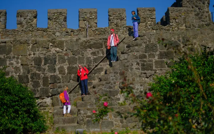 Visitors climbing the stone walls of Gonio-Apsaros Fortress