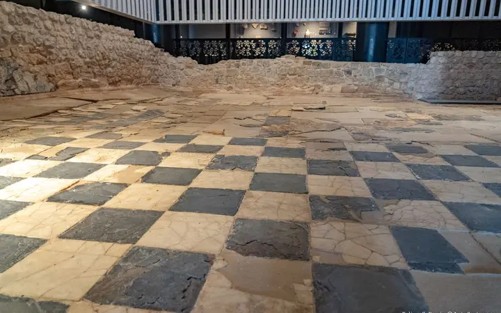 Black-and-white checkered Roman marble floor of the Curia in the Molinete Roman Forum, Cartagena, under a protective roof in daylight