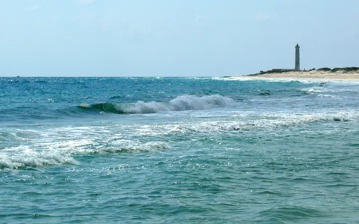 Waves along Cozumel's southeastern shore with the Punta Sur (Celarain) lighthouse in the distance