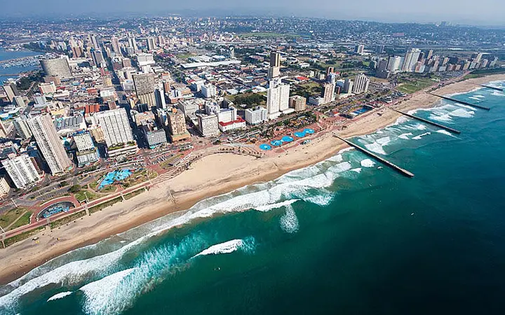 Aerial view of Durban's Golden Mile: beachfront hotels, sandy beaches, piers and surf along the Indian Ocean