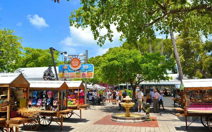 Shops and shaded stalls under large trees at Mallory Square, Key West