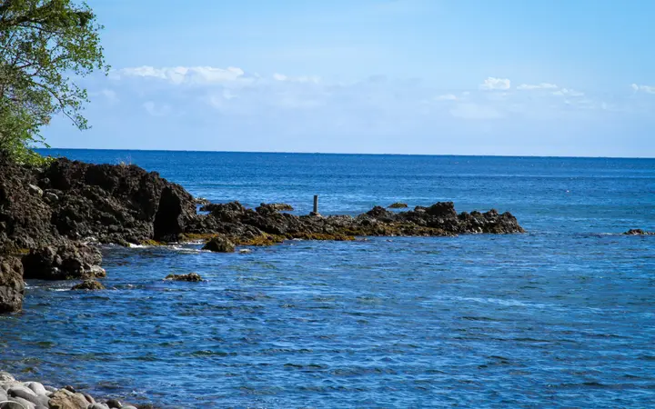 Rocky shoreline and clear blue water at Champagne Beach on Dominica's south-west coast.